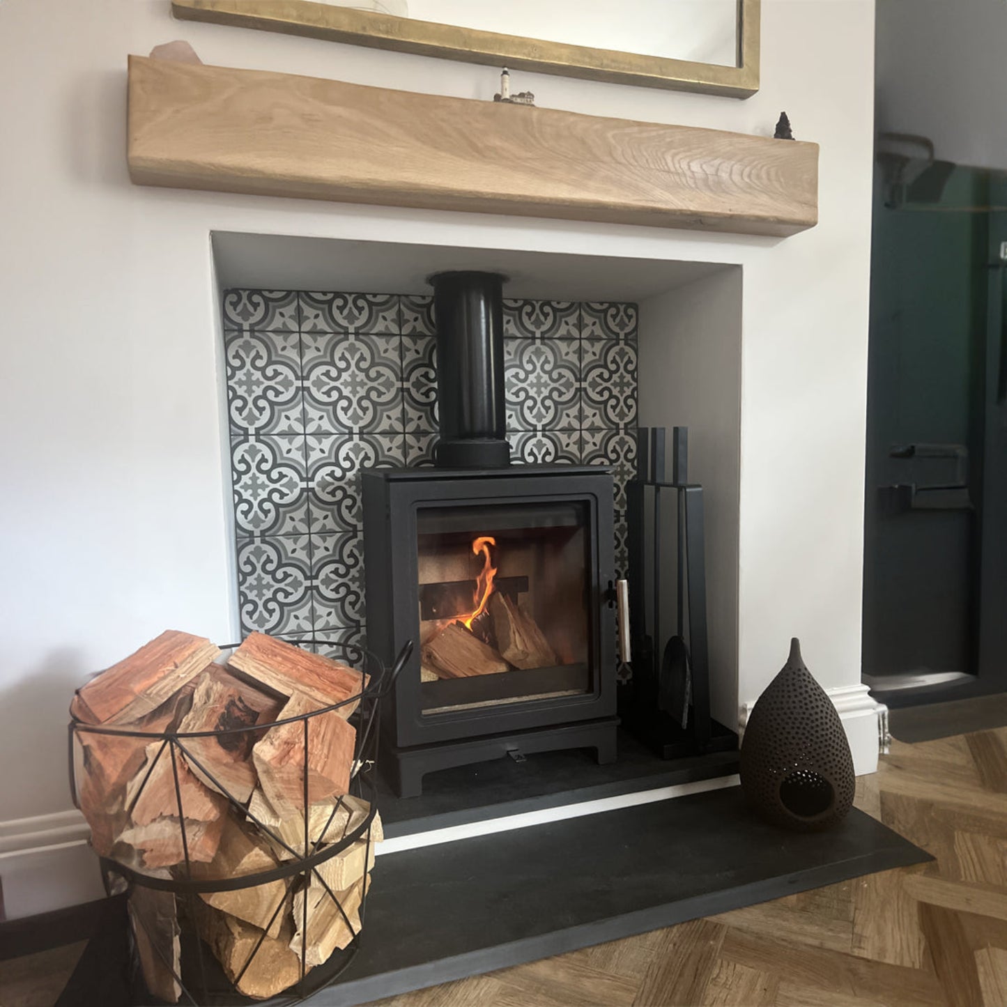 Wood-burning stove in a fireplace with decorative tiles