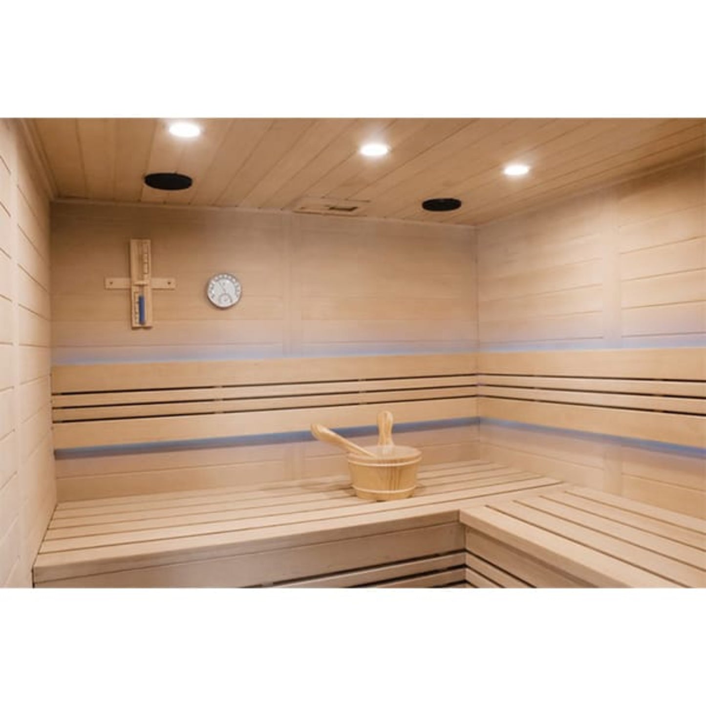 Wooden sauna interior with a thermometer and wooden bucket.