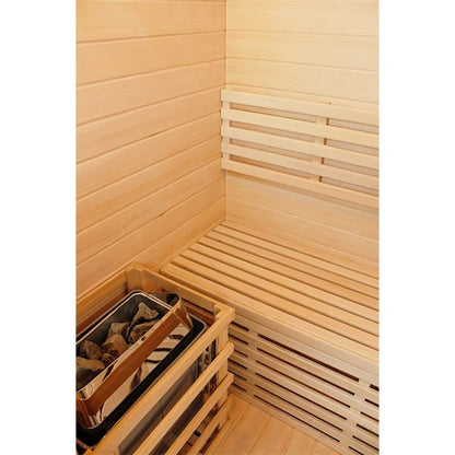 Wooden sauna interior with a bench and basket of stones.