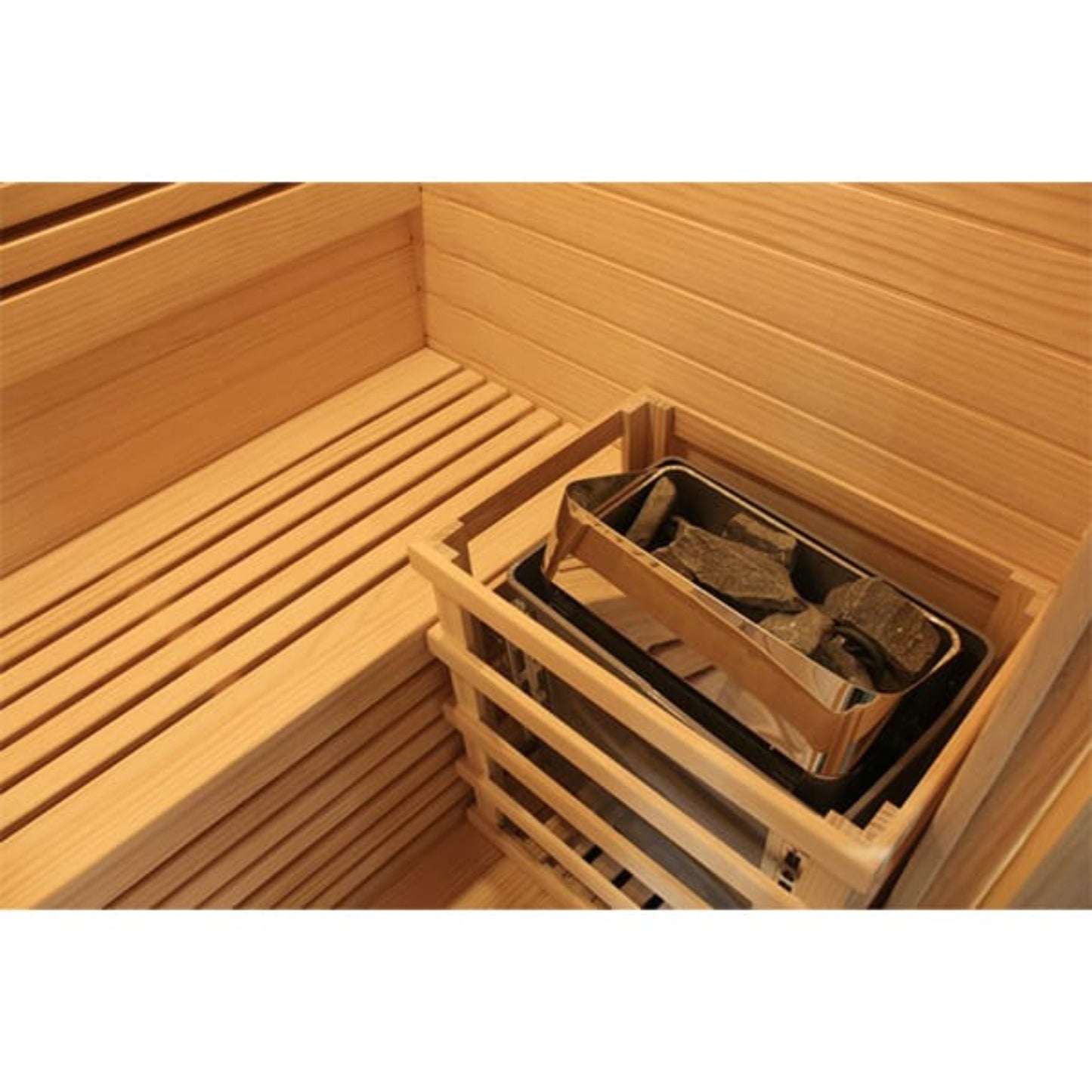 Wooden sauna interior with a heater containing stones.