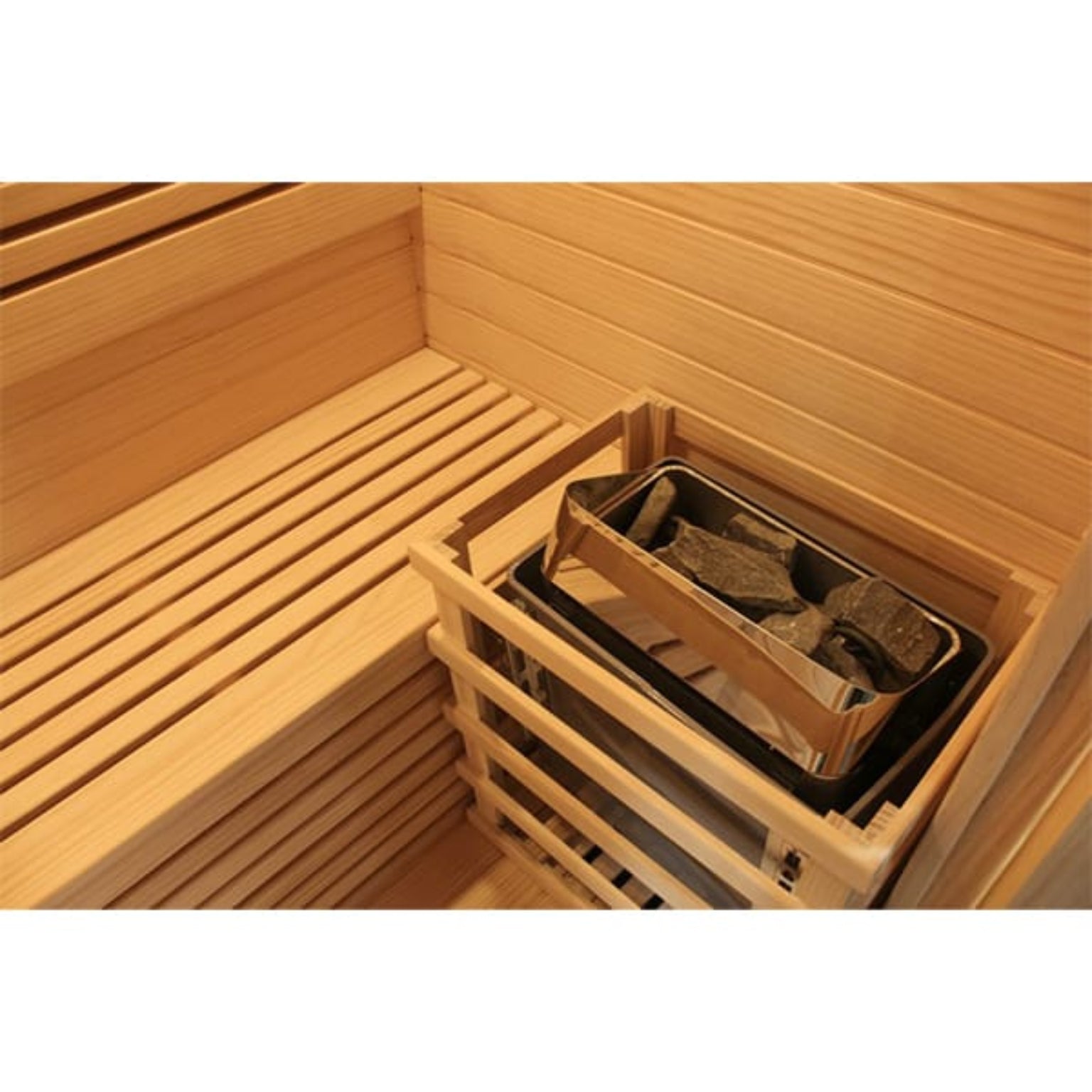 Wooden sauna interior with a heater containing stones.