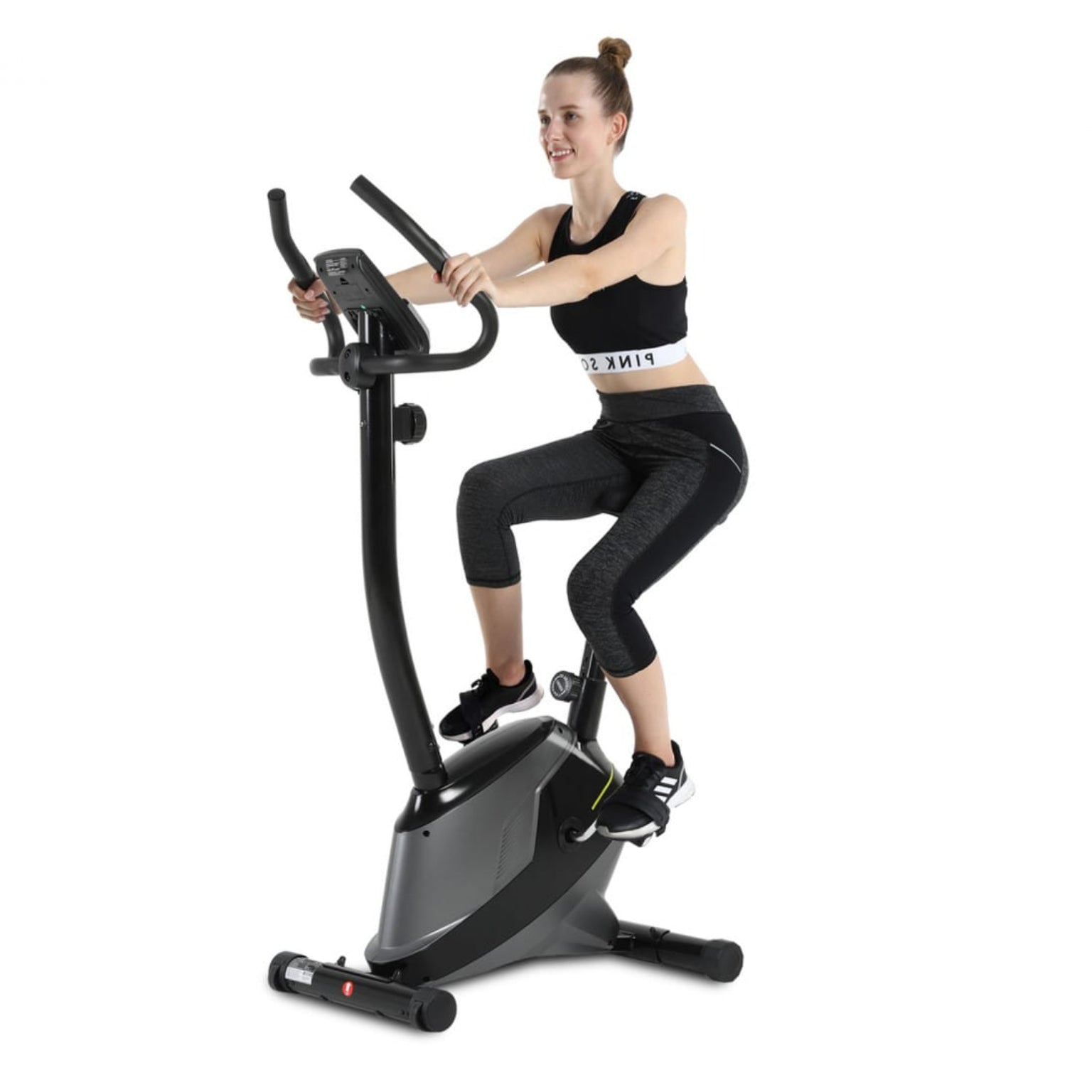 Woman exercising on a Manual Upright Exercise Bike with Adjustable Resistance