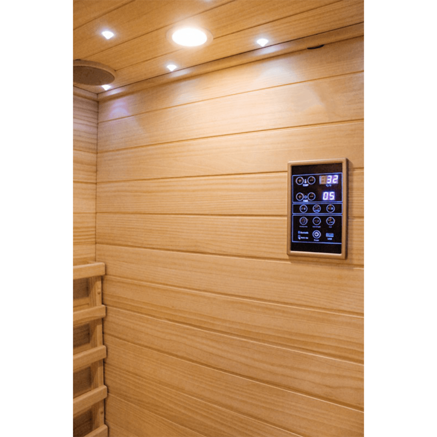 Wooden sauna interior with a digital control panel on the wall.